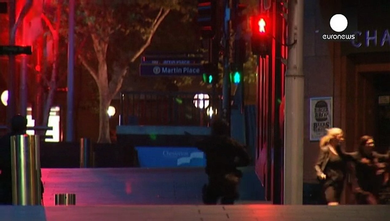 Two hostages and gunman dead after police storm Sydney café where 17 were held hostage