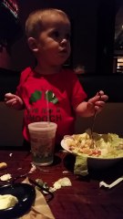 Baby confidently attempts to eat salad with fork