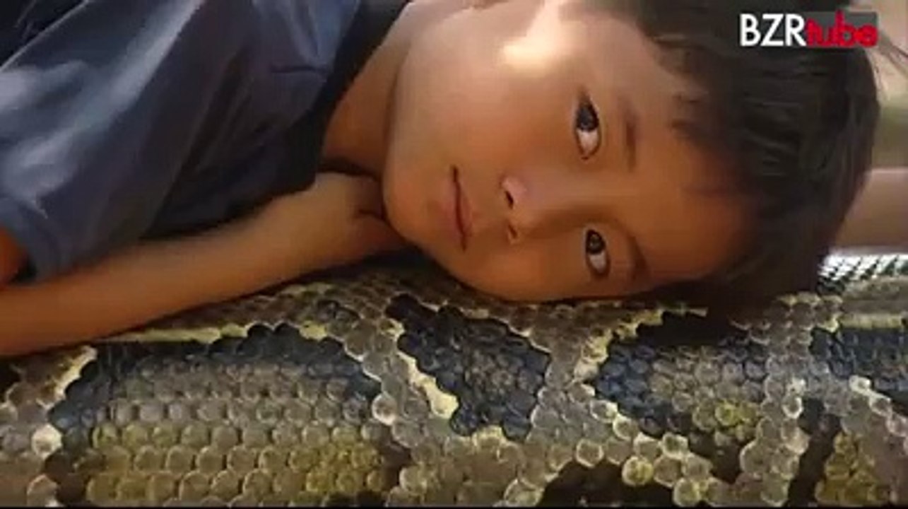 A boy playing with a Python