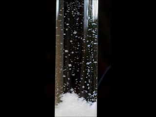 Snow falls in a storm glass (c)