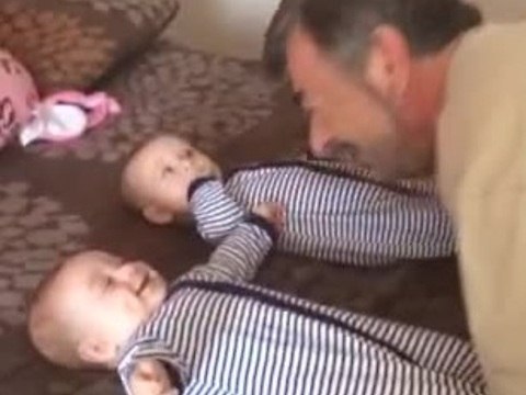Grandpa makes twins laugh simultaneously