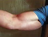 a bodybuilder flexing his huge muscular bicep after a workout