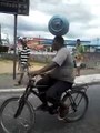 Talented brazilian guy carrying a gas cylinder on his head while riding a bicycle!