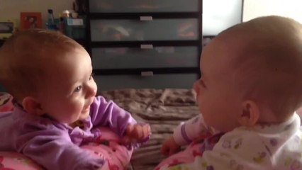 Twin babies talk and hold hands for the first time