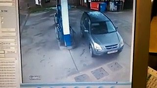 Woman drives round in circles in petrol pump fail.