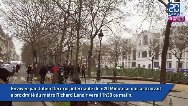 Charlie Hebdo: Un policier à terre après l'attaque.