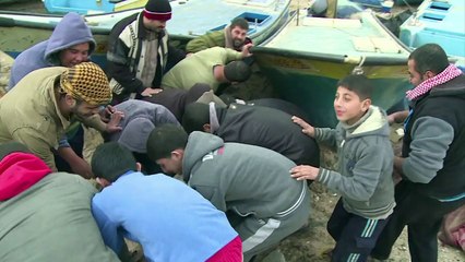 Gaza fisherman protect their boats ahead of a major storm