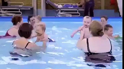 mom learning their 6 month old babies how to swim