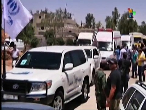 UN aid workers deliver food to the besieged city of Homs