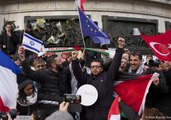 Men Carrying Israeli and Palestinian Flags Embrace in Paris