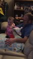 Baby plays peek-a-boo with her dad