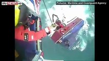 Dramatic helicopter footage shows a fishing boat crew jumping from their sinking vessel - before being winched to safety