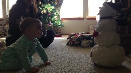 Adorable baby girl sad at melting snowman