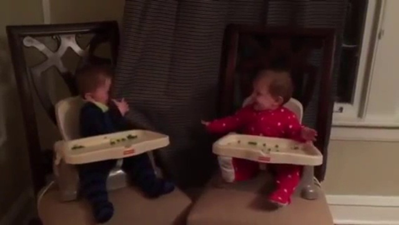 Baby learns how to play peekaboo, then teaches it to his twin