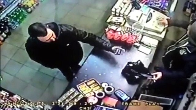 Incredible moment fearless Muslim shopkeeper snatches gun out of thief's hand before chasing him out of the store