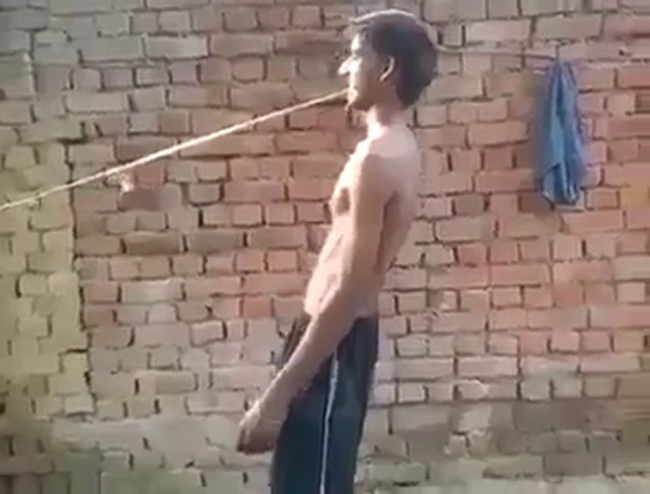 A boy push a tractor with his mouth!!!!