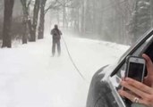 Skiing Through the Streets Behind a Car