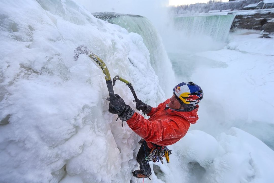 Un homme escalade les chutes du Niagara gelées par le froid