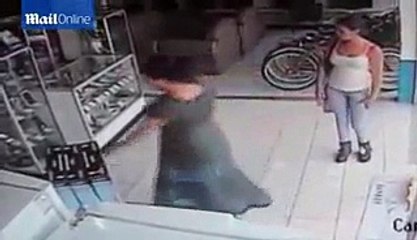 Woman Stuffing a Plasma TV Up Her Skirt