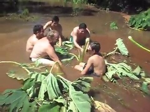 Funny guys trying to unclog a water drain, clog afer a violent storm