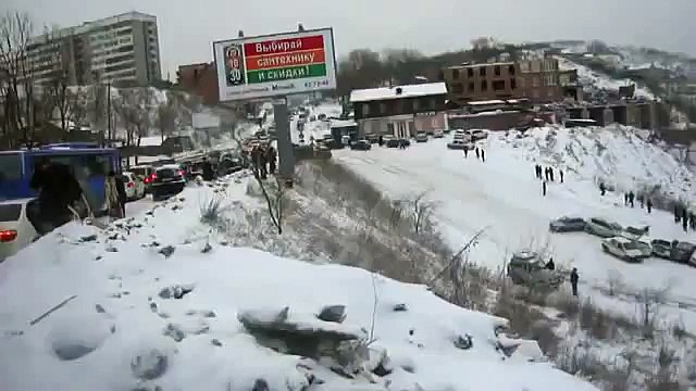 driving down icy hill road gathers cheery spectators