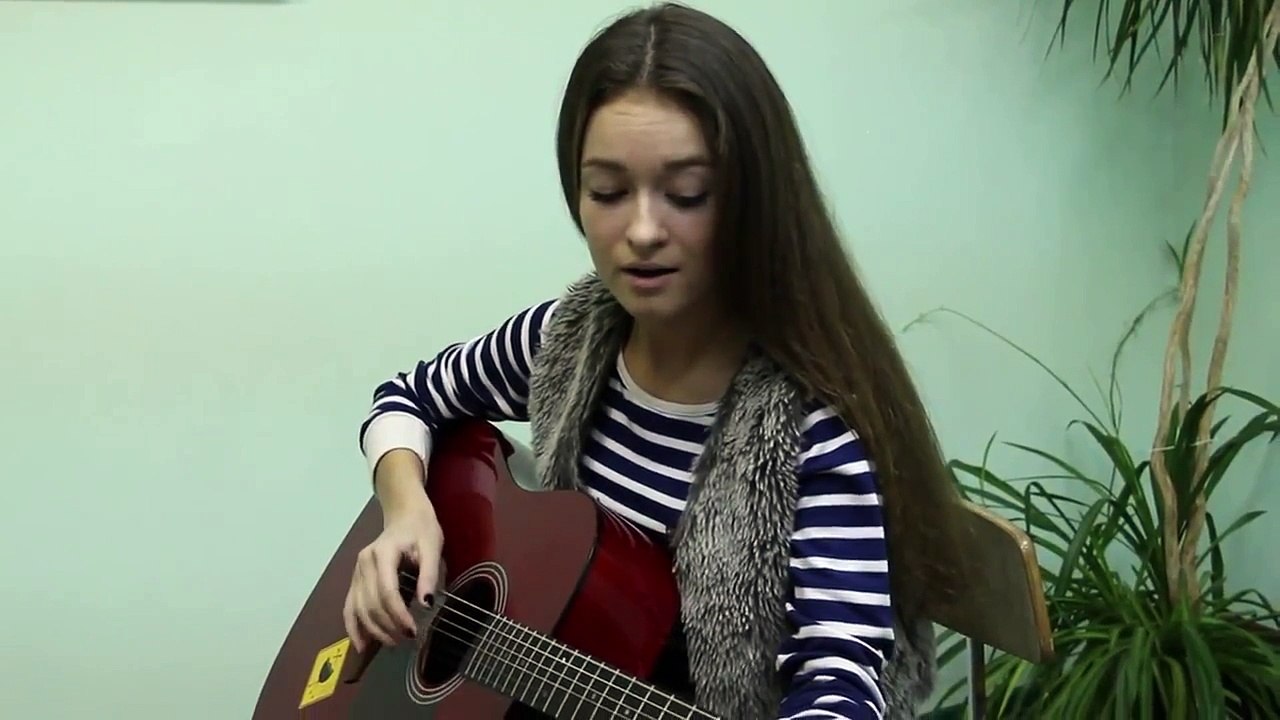 Russian beautiful girl playing the guitar
