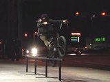 BMX Riders grinds close to a Gas Station