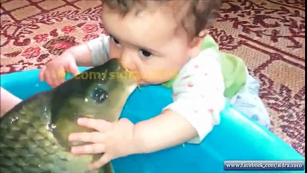 baby and fish playing NICE