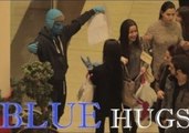 Blue Man Surprises Passers by With Free Blue Hugs for All