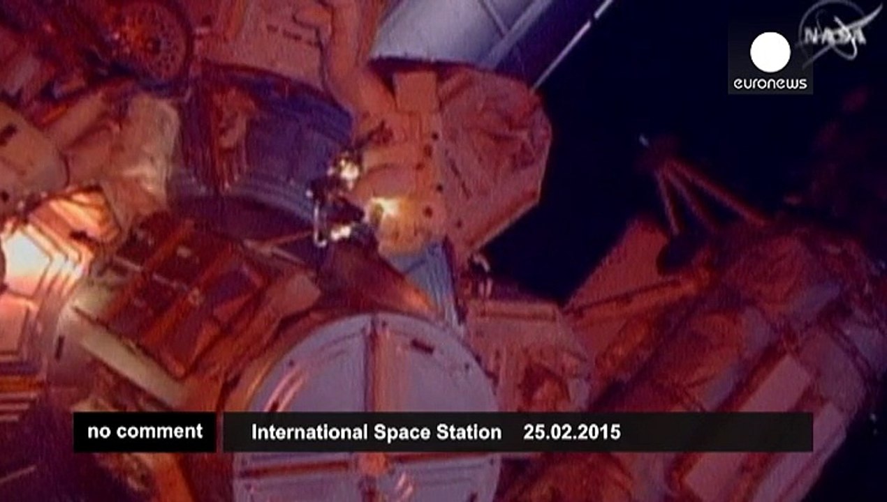 Spacewalking astronauts rig station for new US space taxis