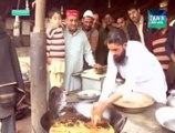 Pakistani man dipping his bare hands into BOILING oil