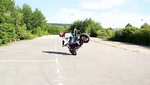 A girls is playing with HER bike and performing stunts