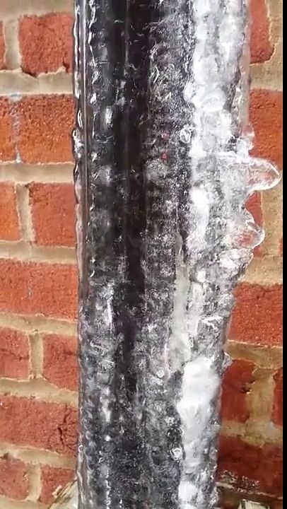 Waterfall Flows Inside Frozen Pipe as Ice Melts