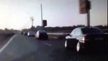 Motorcycle crash, rider flips and lands on feet on car roof