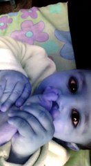 An infant struggle to put his thumb in mouth