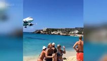 Tourist captures footage of plane passing just overhead of people on Maho Beach