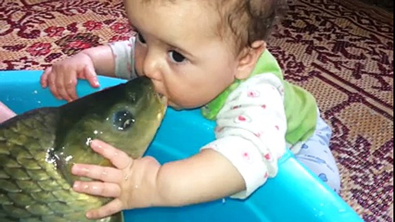 baby with fish - baby kissing fish