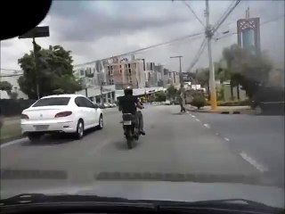 Enraged Motorcyclist Kicks Car and Falls