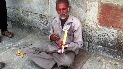 Street performer playing the Airtel tune outside a temple