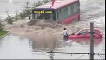 Bus Drives Through Flooded Street - Cool !