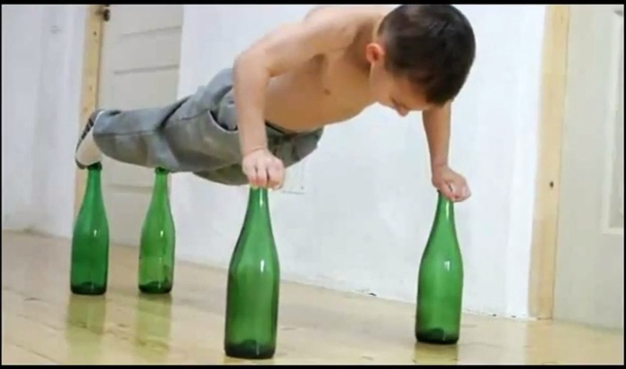 Kid Does Push Ups On Glass Bottles - Funny Videos at Videobash