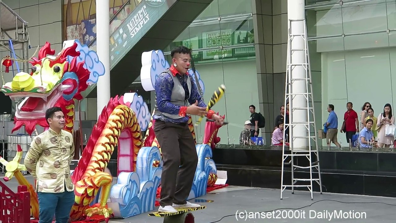 Street Performer in Bangkok Juggles Knives While Balancing. Thailand