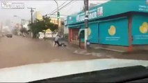 LiveLeak - Biker in a flood is almost swallowed by manhole