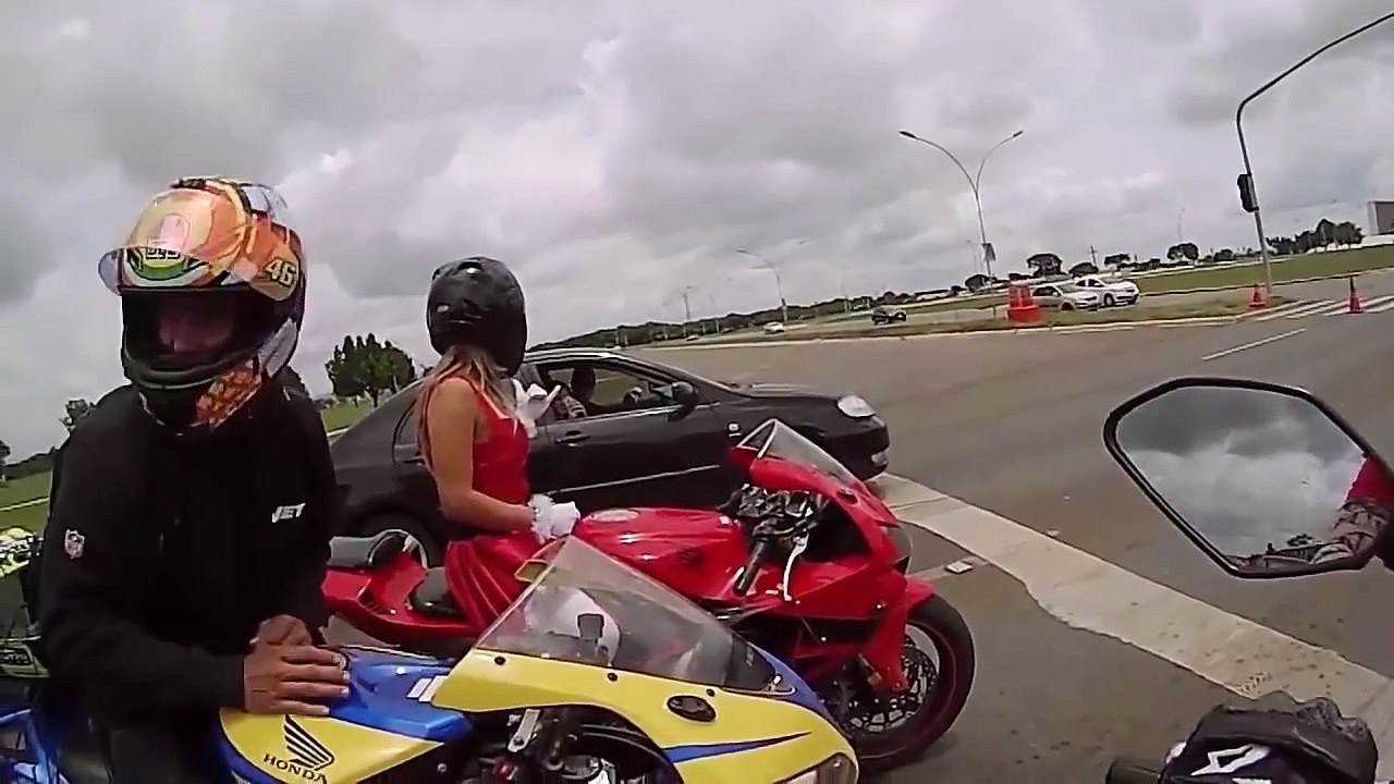 Sexy girl in Santa costume doing wheelies and acrobatic on m