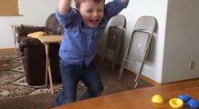 Little Boy Leaps in Delight While Using Easter Toy