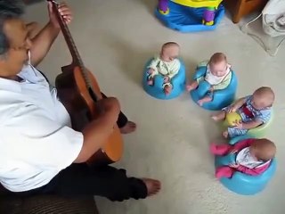 Great uncle plays guitar for new baby quadruplets