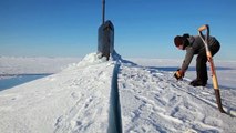 US Navy Sailors Using a Chainsaw to Release a Submarine Blocked by Ice in Artic