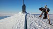 US Navy Sailors Using a Chainsaw to Release a Submarine Blocked by Ice in Artic