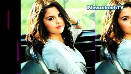 Selena Gomez shows off cut-out cleavage in a swim suit