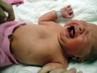 Newborn Baby girl getting dressed leaving hospital